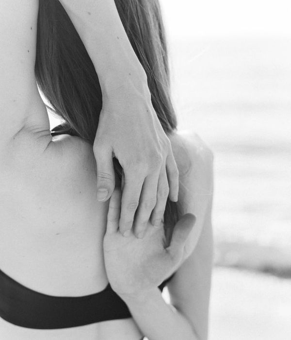 Person feeling energized and stretching outdoors with the sun shining.